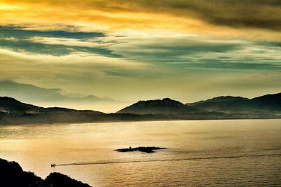 Scenic view of mountains against sky at sunset