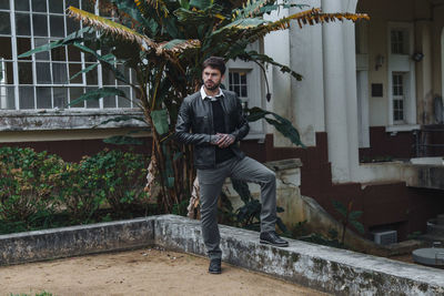 Man standing against plants