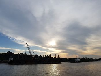 Scenic view of river against sky during sunset