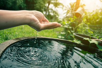 Close-up of hand on water drop