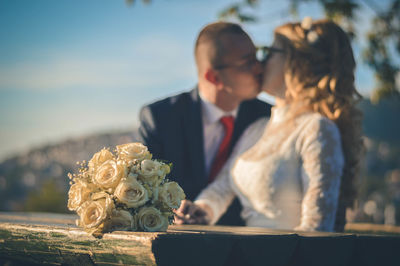 Close-up of couple holding bouquet