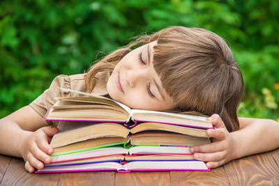 Close-up of young woman reading book