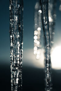 Low angle view of illuminated lighting equipment against sky at night