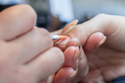 Close-up of hand painting fingernail of customer