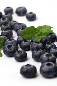 Close-up of fruits on table against white background