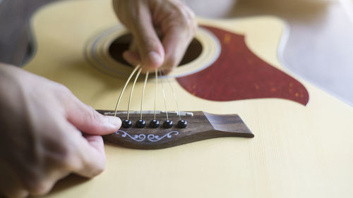 Midsection of man playing guitar