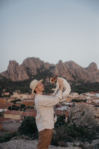 Rear view of man standing against mountain