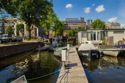 Boats in canal with buildings in background