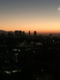 Silhouette of city during sunset