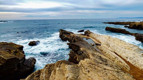 Scenic view of sea against cloudy sky
