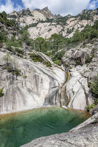 Waterfall and natural pool in purcaraccia canyon in bavella during summer. corsica, france