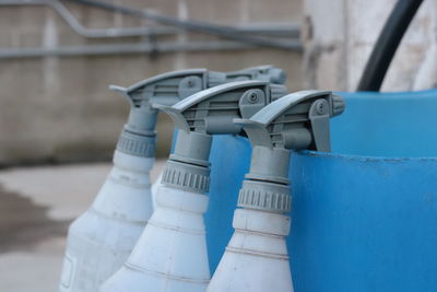 Close-up view of white spray bottles