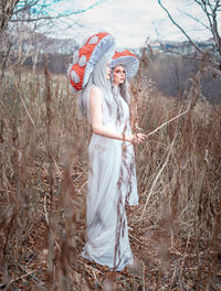 Portrait of woman standing on field