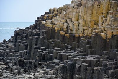 Aerial view of rocks on beach against sky