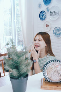 Portrait of young woman sitting at cafe