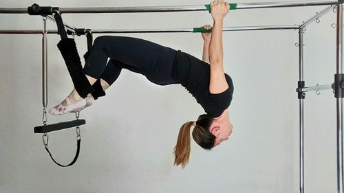 Midsection of man hanging on wall