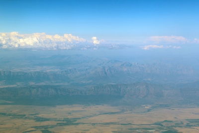 Aerial view of landscape against cloudy sky