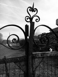 Close-up of metal fence against sky