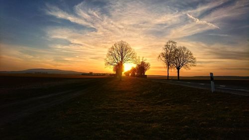 Scenic view of field against sky during sunset