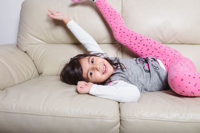 Portrait of girl lying on bed at home