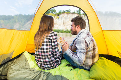 Young couple sitting in tent