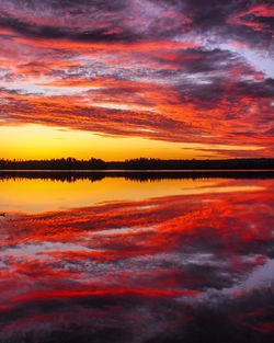 Scenic view of lake against romantic sky at sunset