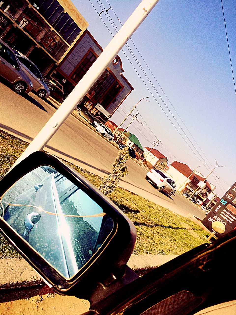 TILT IMAGE OF CAR AGAINST CLEAR SKY