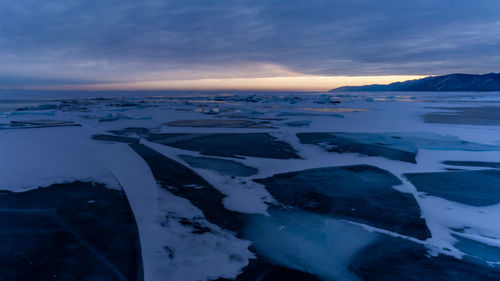 Scenic view of frozen sea against sky during sunset. baykal.