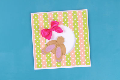 Directly above shot of pink cake on table against blue background