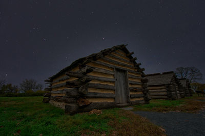 Built structure on field against sky at night