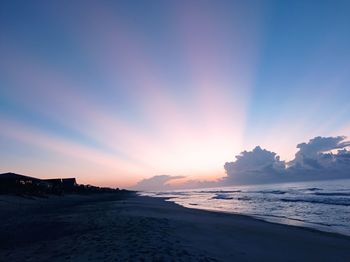 Scenic view of beach against sky during sunset