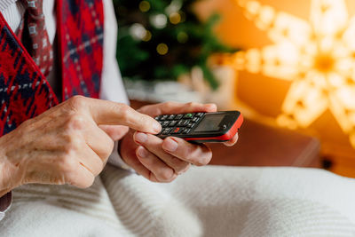 Midsection of man using mobile phone