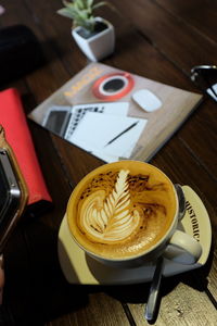 Close-up of cappuccino served on table