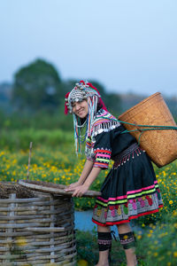 Woman with umbrella standing on field