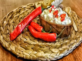 Close-up of red chili peppers in basket on table