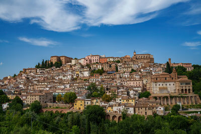 Buildings in town against sky