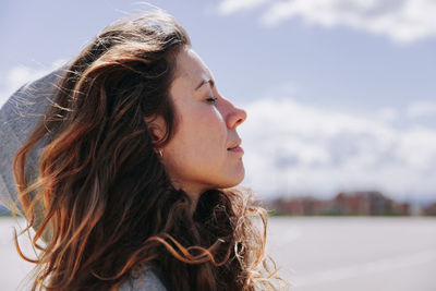 Close-up portrait of young woman looking away