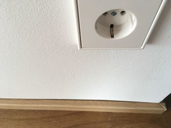 Close-up of electric lamp on hardwood floor at home