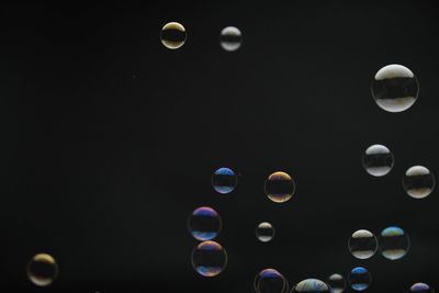 Close-up of bubbles against black background