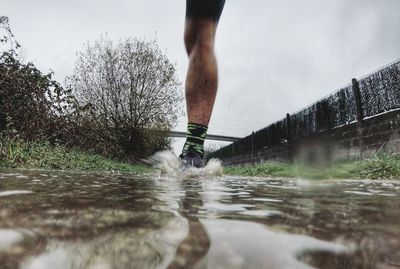 Low section of person running in water