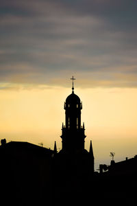 Silhouette building against sky during sunset