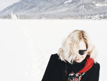 Mid adult woman standing on snow covered mountain