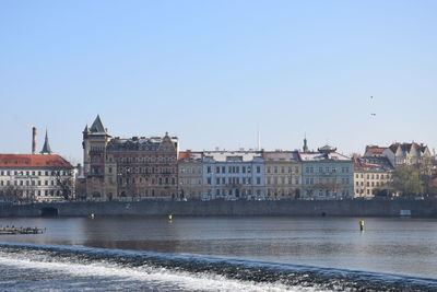 Buildings in city against clear sky