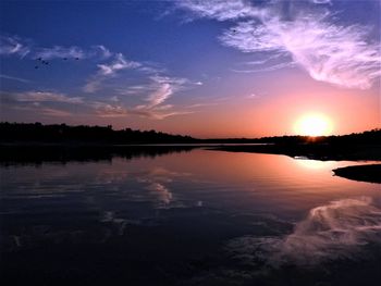 Scenic view of lake against sky during sunset