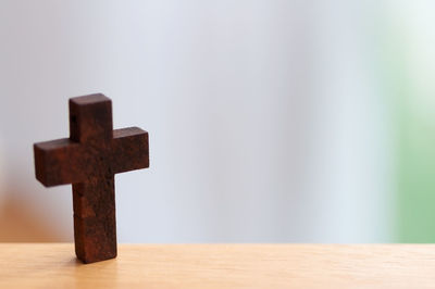 Close-up of cross on table