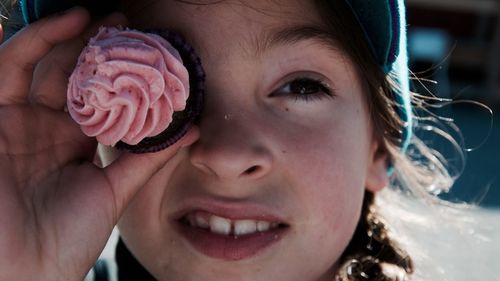 Close-up of girl holding cupcake