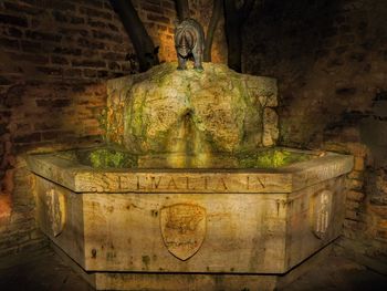 Statue of buddha against wall