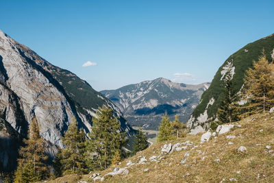 Scenic view of mountains against blue sky