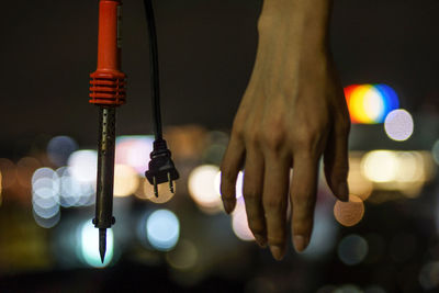 Cropped hand of man holding equipment