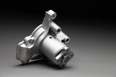 Close-up of machine part against black background